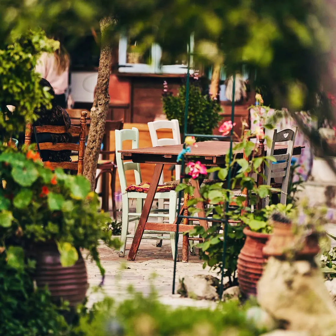 Courtyard seating among flowers at Avli tis Nefelis